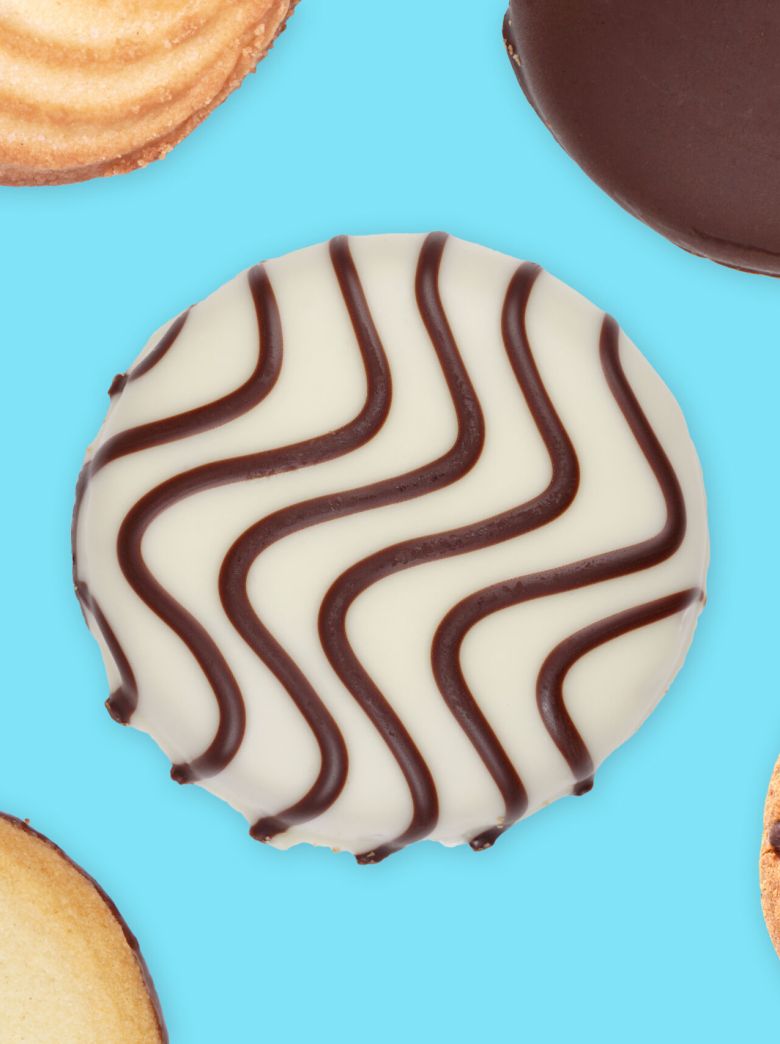 variety of cookies and biscuits on blue background, flat lay